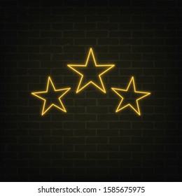 Vector poster of 3 neon light stars set on grunge brick wall background. Shining yellow symbols in retro style. Glowing stars banner for rating cards, templates and your own projects. EPS 10 file.