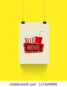 Vector poster hanging on paper clips with pop corn basket, cola cup and movie sign on yellow background. Cinema banner template