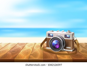 Vector realistic vintage retro film photo camera on wooden floor deck timbers walkway beach coast coastline, seaside, seashore background sand, blue sea ocean summer sky. Holiday vacation travel