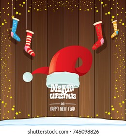 vector red Santa hat  with christmas socks and greeting text Merry Christmas and Happy new year on wooden background. vector merry christmas greeting card, banner design template or xmas background. 