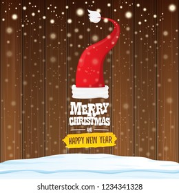 vector red Santa hat with greeting text Merry Christmas and happy new year on wooden background with falling snowflakes. Funny Merry christmas greeting card, banner or poster xmas background.