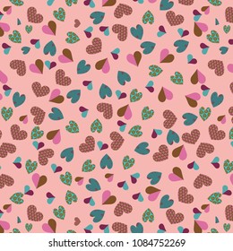vector repeating pattern of decorated green and pink colored hearts over peach background. soft pattern for textile, fabric and decorative surface designs