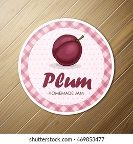 Vector round label, plum jam on a wooden background