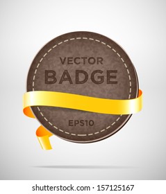 Vector round vintage leather badge with yellow silky ribbon