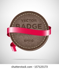Vector round vintage leather badge with red silky ribbon