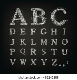 Vector scribbled alphabet in a black board