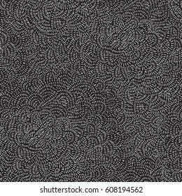 Vector seamless abstract pattern from white hand drawn chaotic round lines on a dark black background. 
