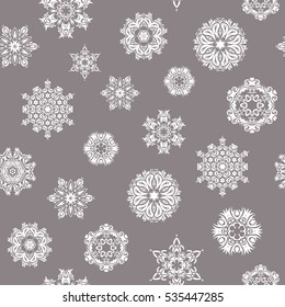 Vector seamless background for Christmas with decorative snowflakes. Pattern on gray background. Design.