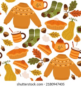 Vector seamless background with cozy elements. Autumn pattern with sweater, socks, pie, cocoa, pumpkins, teapot, leaves and acorns. Bright repeating texture. Wrapping paper.