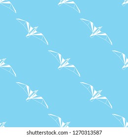 Vector seamless background with flying seagulls. Modern polygonal  design. Origami birds. Flat design pattern 