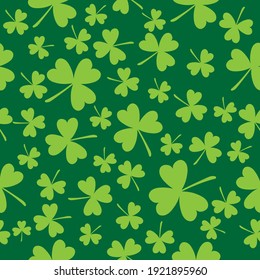 Vector seamless background on theme of St. Patrick's Day. Three-leaf clover on green background.