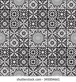 Vector seamless background of tiles decorated with patterns. Stylized flowers, geometric shapes. Black and white abstract tile.