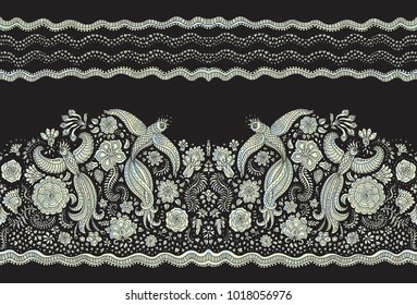 Vector seamless border in ethnic style. Exotic flying peacock birds, light pearl colored folk ornaments on a black background. Embroidery edge, wallpaper fringe, textile print, wrapping paper