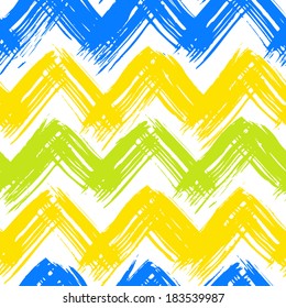 Vector seamless chevron pattern hand painted with bold brushstrokes in bright multiple colors: yellow, blue, lime green and white