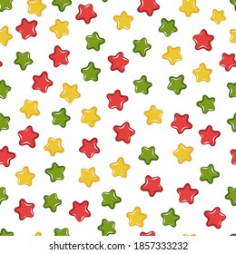 Vector seamless Christmas pattern with festive confetti stars. Red, green, yellow stars on white background. Fruit jelly beans. Good for wrapping paper, celebration cards, textile, kids print.