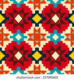 Vector seamless ethnic pattern with american indian motifs in multiple colors. Colorful aztec background. Textile print with navajo tribal ornament. Native american art.