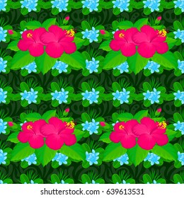 Vector seamless floral pattern with hibiscus flowers and leaves on a green background.