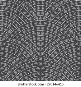 Vector seamless floral pattern from white stylized flower silhouette and pearls beads on dark grey background. Geometrical fish scale layout