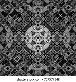 Vector seamless geometric pattern of white and black tiles.