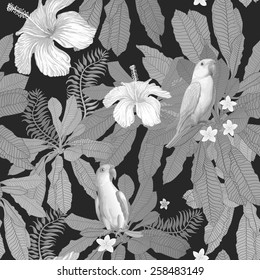 Vector seamless grey-scale floral pattern from hand drawn hibiscus and plumeria flowers, Indian  parrots, and fantasy tropical foliage at the black background