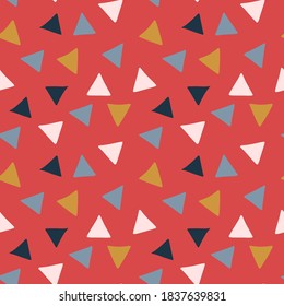 Vector seamless hand drawn geometrical pattern with colourful triangles on red background perfect for Christmas wrapping paper or other design