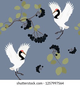 Vector seamless illustration with birds cranes and black chokeberry branches. For decoration of textiles, packaging, wallpaper, web design.