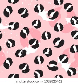 Vector seamless leopard pattern. Abstract black and white spots on pink background. Modern design