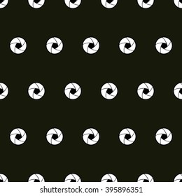 vector seamless pattern with abstract lens on a dark brown background