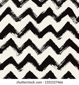Vector seamless pattern. Abstract textured background with zigzag brush strokes. Monochrome hand drawn print with chevron design.