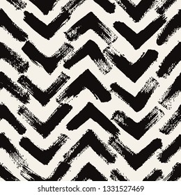 Vector seamless pattern. Abstract textured background with zigzag brush strokes. Monochrome hand drawn print with chevron design.