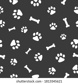 Vector, seamless pattern. Abstraction,, white traces of paws of a cat, dog, bones on a dark gray background. For prints, packaging, social media, web.