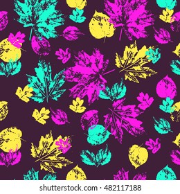 Vector seamless pattern with acrylic leaf prints. Bright pink, green and yellow leaves on dark background. 