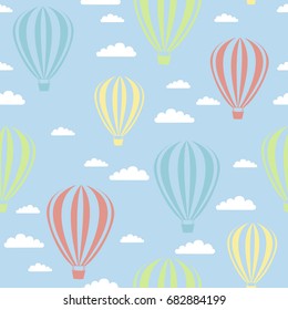 vector seamless pattern with air balloons, clouds. Hot air balloons with cute clouds seamless pattern. Bright colors hot air balloons design. Baby shower vector illustrations on blue sky background. 