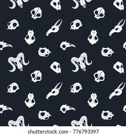 Vector seamless pattern of animal skulls. Background with cute skulls on the black background.