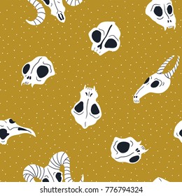 Vector seamless pattern of animal skulls. Background with cute skulls on the golden  polka dot  background.