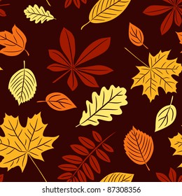 Vector seamless pattern with autumn many-colored leaves on the dark background.