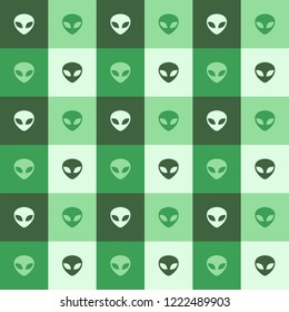 Vector seamless pattern background made with alien faces inside green squares