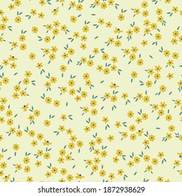 Vector seamless pattern. Beautiful pattern in abstract yellow colors. Small yellow flowers. Pale yellow background. Elegant template for fashionable prints.