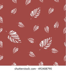 Vector seamless pattern of big and small leaves in a chaotic manner. Leaves silhouettes on the dark background. Autumn simple design