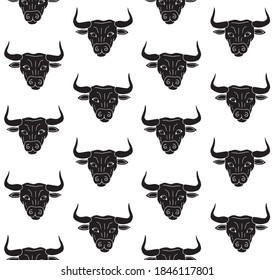 Vector seamless pattern of black hand drawn doodle sketch bull face isolated on white background