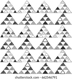 Vector seamless pattern with black hand drawn pyramids on white background.