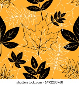 Vector seamless pattern with black and white autumn leaves on a yellow background.