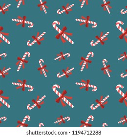 Vector seamless pattern candy cane on a blue background. Seamless texture for wallpaper, web page background, wrapping paper, New Year textile in retro style.