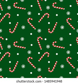 Vector seamless pattern with candy cane sweet sticks. Christmas or New Year festive background. Template for wrapping paper, gift, fabric or textile. Red candies and snowflakes on green background