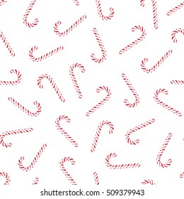 Vector seamless pattern with candy canes. Red striped Christmas peppermint sticks on white background.