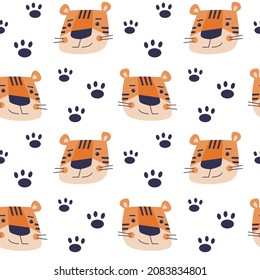 Vector seamless pattern with cartoon tigers muzzles and paws.