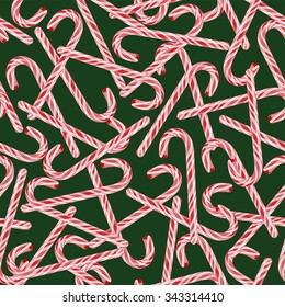 Vector seamless pattern with Christmas candy cane isolated on green background