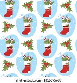 Vector seamless pattern with Christmas stockings and holly branches. Winter holiday background. Texture for textile or wrapping paper.