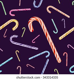 Vector seamless pattern with colored Christmas candy cane isolated on violet background