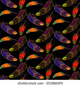 Vector seamless pattern with colored feathers on a black background. It can be used for fabric or wrapping.